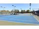 Well-maintained tennis courts with covered seating areas at 9789 E Cinnabar Ave, Scottsdale, AZ 85258