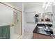 Bathroom with shower, vanity, and black countertop at 9802 N Balboa Dr, Sun City, AZ 85351