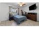 Cozy bedroom with tiled floor, dresser, and ceiling fan at 9802 N Balboa Dr, Sun City, AZ 85351