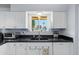 Kitchen sink and countertop with window overlooking patio at 9802 N Balboa Dr, Sun City, AZ 85351