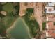 Aerial view of homes near a golf course and lake at 10009 E Michigan Ave, Sun Lakes, AZ 85248