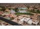 Aerial view showcasing community, golf course, and lake at 10009 E Michigan Ave, Sun Lakes, AZ 85248