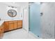 Bright bathroom boasts wood cabinets, a large shower, and updated fixtures at 10009 E Michigan Ave, Sun Lakes, AZ 85248