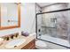 Bathroom features a shower/tub combo, wood vanity, and tile flooring at 10009 E Michigan Ave, Sun Lakes, AZ 85248