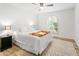 Bright bedroom with wood flooring, an arched window, and ceiling fan at 10009 E Michigan Ave, Sun Lakes, AZ 85248