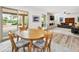 Bright dining area with wood table and chairs, view of backyard at 10009 E Michigan Ave, Sun Lakes, AZ 85248