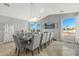 Elegant dining room with large windows, chandelier, and seating for ten at 1106 E Circle Mountain Rd, New River, AZ 85087