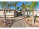 Inviting curb appeal with palm trees and a paved walkway leading to the entrance at 1106 E Circle Mountain Rd, New River, AZ 85087