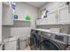 Bright laundry room with washer, dryer, and ample storage at 1106 E Circle Mountain Rd, New River, AZ 85087