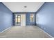 Bedroom with blue walls, carpet, and sliding door to patio at 11386 W Buchanan St, Avondale, AZ 85323