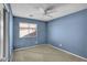 Bright bedroom with ceiling fan and neutral carpeting at 11386 W Buchanan St, Avondale, AZ 85323