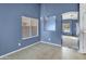 Dining area with tile floor, chandelier, and blue walls at 11386 W Buchanan St, Avondale, AZ 85323