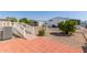 Landscaped backyard with brick patio and access ramp at 11596 W Sierra Dawn Blvd # 109, Surprise, AZ 85378