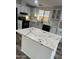 Close-up of a kitchen island with beautiful marble countertop and white cabinets at 11596 W Sierra Dawn Blvd # 109, Surprise, AZ 85378