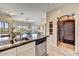 Kitchen with island, view of living room and tile feature at 12050 N Panorama Dr # 208, Fountain Hills, AZ 85268