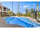 Community pool with surrounding patio and trees at 12050 N Panorama Dr # 208, Fountain Hills, AZ 85268