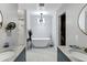 Elegant bathroom with a freestanding soaking tub, double vanity, and marble countertops at 1233 E Monte Vista Rd, Phoenix, AZ 85006