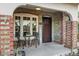 Inviting front porch with brick columns, wrought iron chairs, and a welcoming entrance at 1233 E Monte Vista Rd, Phoenix, AZ 85006