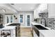 Modern kitchen with white cabinets, farmhouse sink, and island with cooktop at 1233 E Monte Vista Rd, Phoenix, AZ 85006