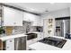 Updated kitchen featuring white cabinets, a farmhouse sink, and stainless steel appliances at 1233 E Monte Vista Rd, Phoenix, AZ 85006