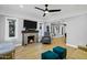 Bright living room with hardwood floors, fireplace, and a ceiling fan at 1233 E Monte Vista Rd, Phoenix, AZ 85006