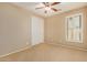 Spacious bedroom with neutral carpeting and large window with plantation shutters at 1306 E Cecil Ct, Casa Grande, AZ 85122