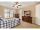 Well-lit bedroom with wood flooring, a ceiling fan, and built in dresser at 1306 E Cecil Ct, Casa Grande, AZ 85122