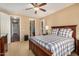 Cozy bedroom with wood flooring, a ceiling fan, and a walk-in closet at 1306 E Cecil Ct, Casa Grande, AZ 85122