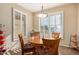 Breakfast nook with a round table and four chairs, offering ample natural light at 1306 E Cecil Ct, Casa Grande, AZ 85122