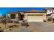 Tan colored house with tile roof and desert landscaping at 1306 E Cecil Ct, Casa Grande, AZ 85122