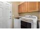 Convenient laundry room with washer, dryer, and upper cabinets at 1306 E Cecil Ct, Casa Grande, AZ 85122