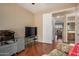 Home office features hardwood floors, a printer, and view into Primary bathroom at 1306 E Cecil Ct, Casa Grande, AZ 85122