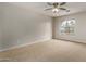 Spacious bedroom with a large window and ceiling fan at 13332 W Palo Verde Dr, Litchfield Park, AZ 85340