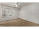 Well lit bedroom with window and ceiling fan at 13332 W Palo Verde Dr, Litchfield Park, AZ 85340