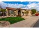 Two-story home with a three-car garage and artificial turf at 13332 W Palo Verde Dr, Litchfield Park, AZ 85340