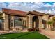 Two-story home with a three-car garage and manicured lawn at 13332 W Palo Verde Dr, Litchfield Park, AZ 85340