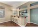 Modern home bar with granite countertop and two stools at 13332 W Palo Verde Dr, Litchfield Park, AZ 85340