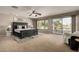 Large main bedroom with plush carpeting and sliding doors to a balcony at 13332 W Palo Verde Dr, Litchfield Park, AZ 85340