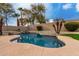 Relaxing freeform pool with waterfall feature in backyard at 13332 W Palo Verde Dr, Litchfield Park, AZ 85340