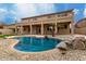 Inviting kidney-shaped pool surrounded by rocks and gravel at 13332 W Palo Verde Dr, Litchfield Park, AZ 85340