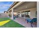 Covered patio with lounge chairs and a view of the grassy backyard at 1520 W Sonoqui Blvd, San Tan Valley, AZ 85140