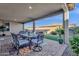 Covered patio with table and chairs, overlooking the grassy backyard at 1520 W Sonoqui Blvd, San Tan Valley, AZ 85140