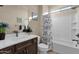 Clean bathroom with a shower/tub combo and dark brown vanity at 1520 W Sonoqui Blvd, San Tan Valley, AZ 85140