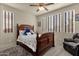 Spacious bedroom with a wooden bed frame and large windows at 1520 W Sonoqui Blvd, San Tan Valley, AZ 85140