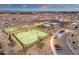 Well-lit tennis courts surrounded by desert landscaping at 1520 W Sonoqui Blvd, San Tan Valley, AZ 85140