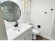 Modern bathroom with round mirror and white vanity at 1539 E 3Rd St, Mesa, AZ 85203