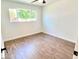 Bright bedroom with wood-look flooring and ceiling fan at 1539 E 3Rd St, Mesa, AZ 85203