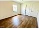 Bright bedroom with wood-look floors and ample closet space at 1539 E 3Rd St, Mesa, AZ 85203