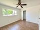 Bedroom with wood-look floors, a ceiling fan, and large window at 1539 E 3Rd St, Mesa, AZ 85203