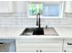 Modern kitchen features a farmhouse sink and sleek black faucet at 1539 E 3Rd St, Mesa, AZ 85203